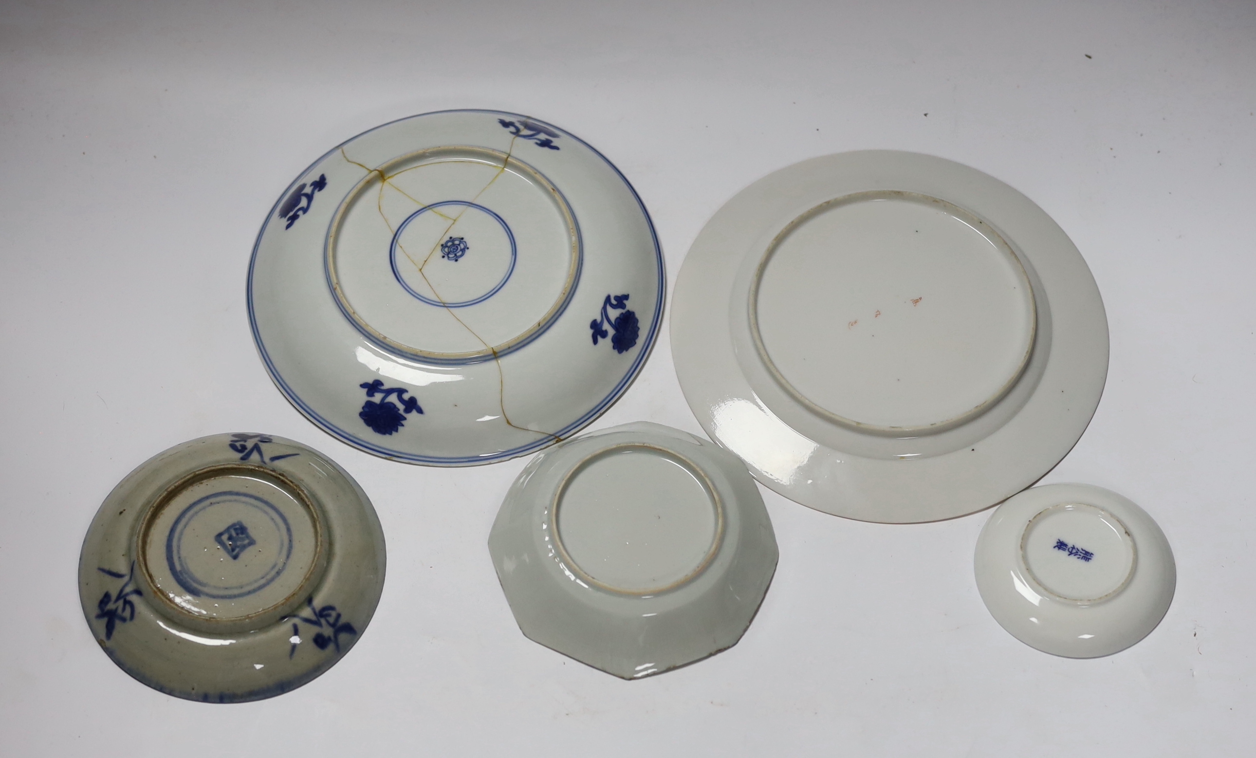 A group of 18th century Chinese porcelain plates and saucers, mostly blue and white and an octagonal famille rose example, together with three Japanese dishes, largest 27cm in diameter